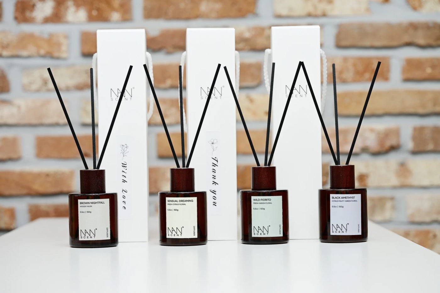나노센트 스틱 디퓨저 150ml 네 가지 제품을 흰 선반 위에 둔 모습